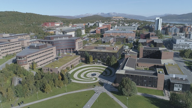 Arctic Frontiers - Aerial view of a modern university campus with green roofs and a circular courtyard design, captured in stunning detail by Arctic Frontier Partner pictures.