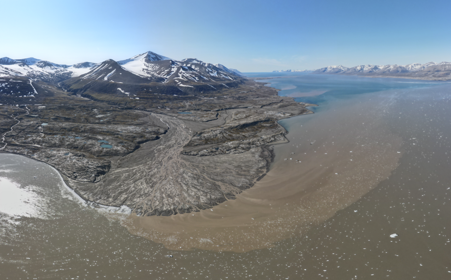Glacier with sediment meeting an ocean