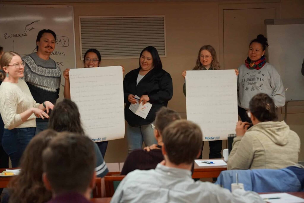 Arctic Frontiers - Five people present handwritten posters to a classroom; seated pupils watch and listen attentively.